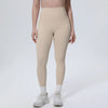 A model wearing beige high-waisted quick-drying yoga and fitness leggings with white socks and white athletic shoes.