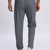 A pair of charcoal gray breathable men's casual jogger pants being worn by a person.