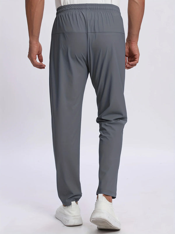 A pair of charcoal gray breathable men's casual jogger pants being worn by a person.