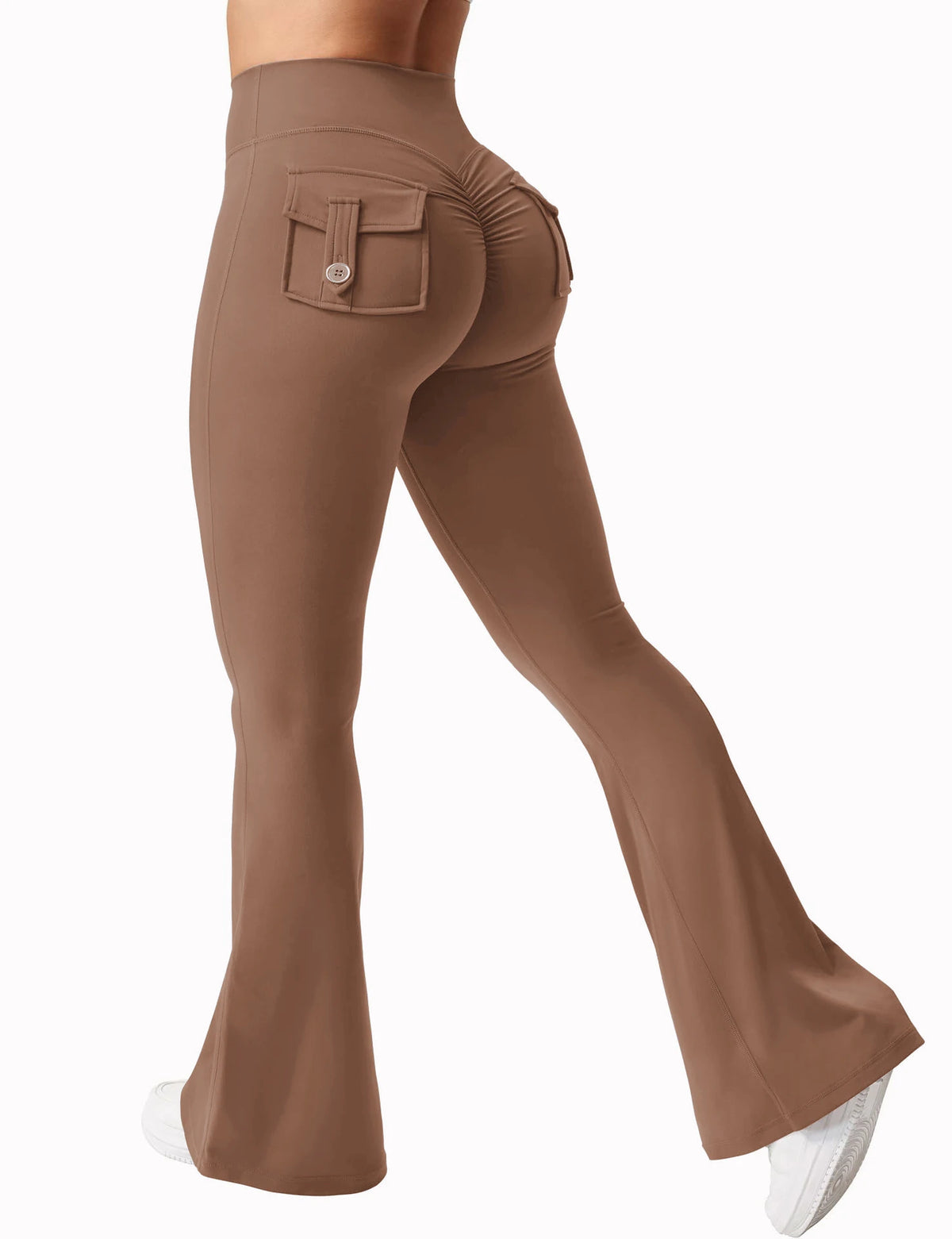 A close-up shot of a woman wearing brown high stretch yoga leggings with a front pocket.