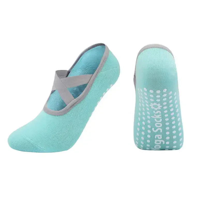 A pair of light teal silicone anti-slip pilates and yoga socks shown from the side.