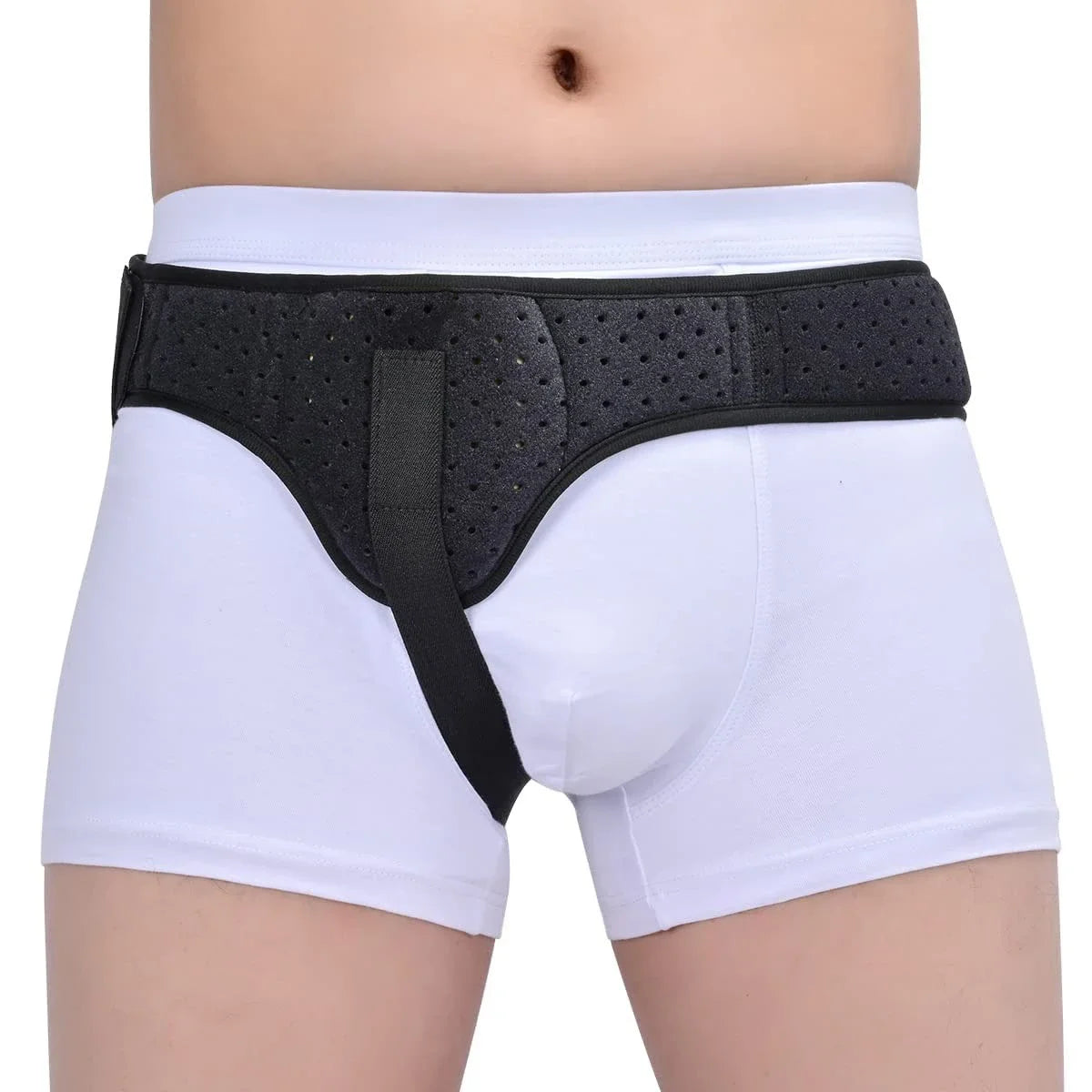 Black inguinal hernia support belt with compression pads worn over white underwear.