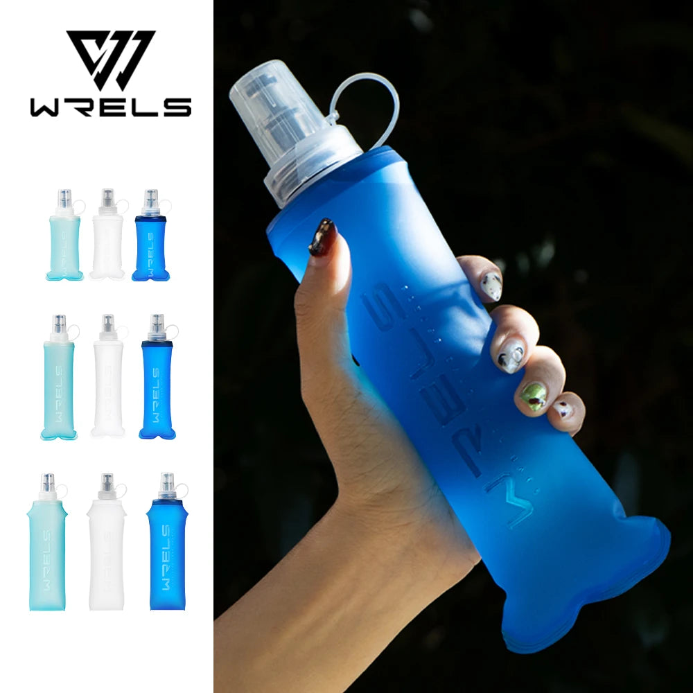 A hand holds a blue collapsible silicone water flask against a dark background.