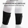 White segmented micro-pressure shin guards worn on a leg with black compression sleeves.