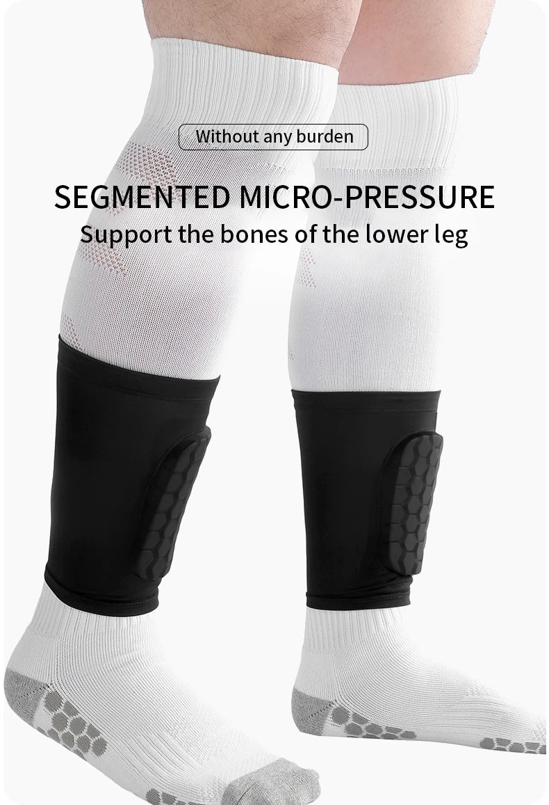 White segmented micro-pressure shin guards worn on a leg with black compression sleeves.