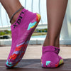 A close-up of a bright pink waterproof quick-dry outdoor hiking shoe worn on a person's foot.