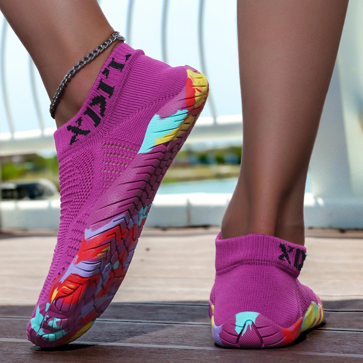 A close-up of a bright pink waterproof quick-dry outdoor hiking shoe worn on a person's foot.