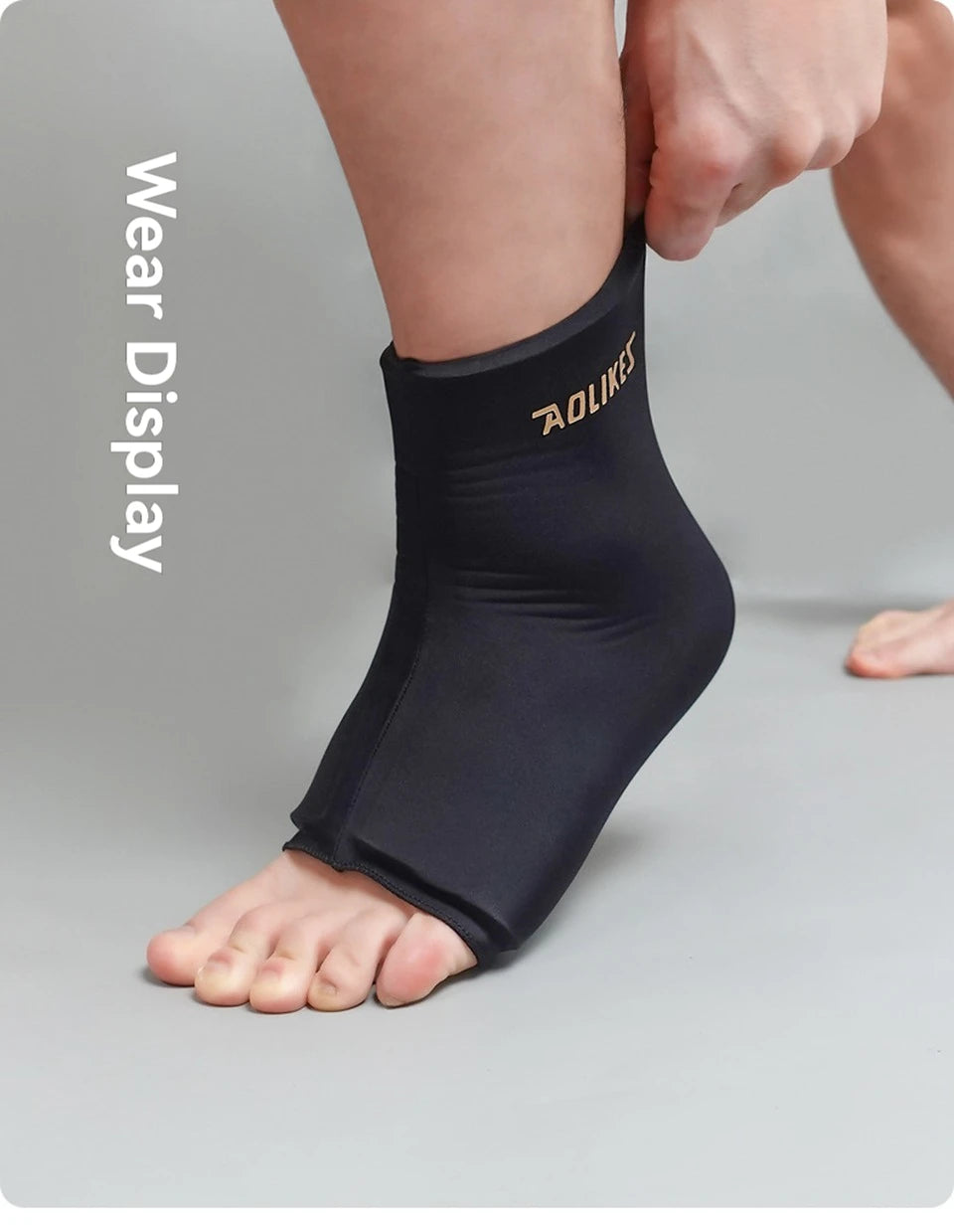A person is wearing a black knee sleeve for hot and cold therapy on their lower leg.