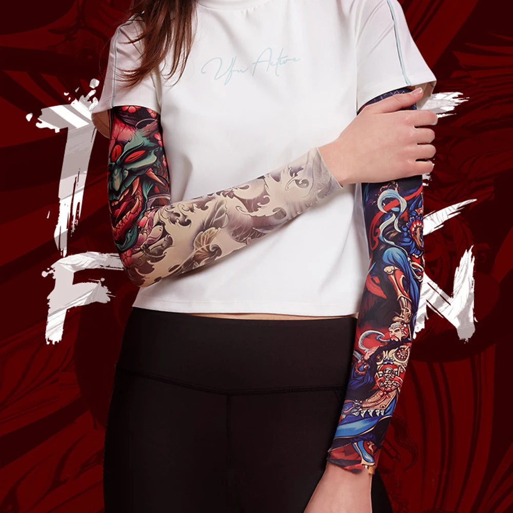 A person wearing a white t-shirt and black leggings with long, colorful tattoo sleeves.