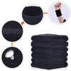 A stack of six black sweat-absorbing sports wrist guards shown next to a single guard on a hand.