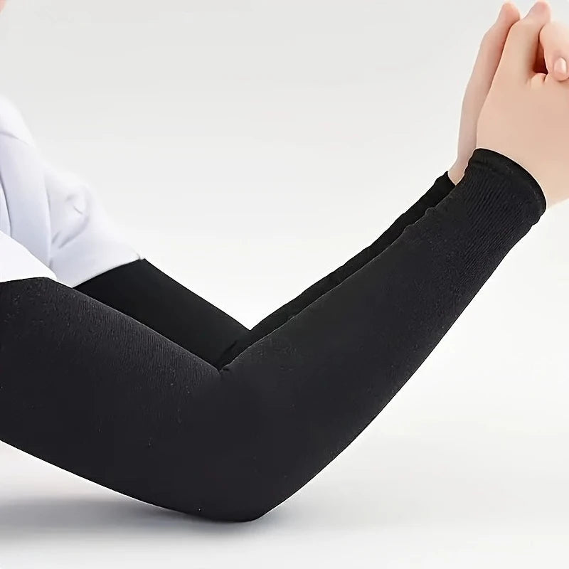 Black neoprene arm guards worn on a hand and forearm, showing the protective sleeve design.