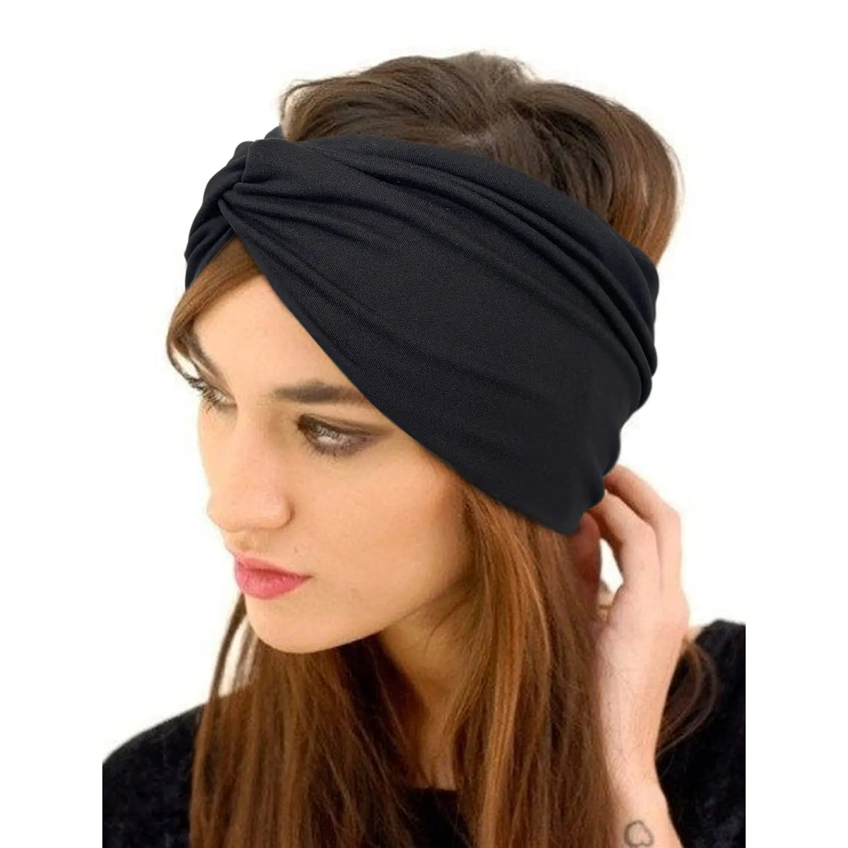 Una mujer usando una cinta bohemia ancha negra envuelta en su cabello.