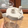 A clear water bottle with a white sports straw lid and time scale visible on the top.