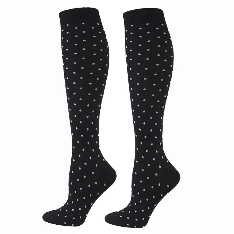 Pair of black compression elastic socks with a small white dot pattern