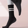 Black non-slip yoga socks with white stripes and textured grip