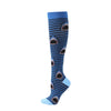 A pair of blue compression socks with a repeating pattern of stylized fish or shark teeth.