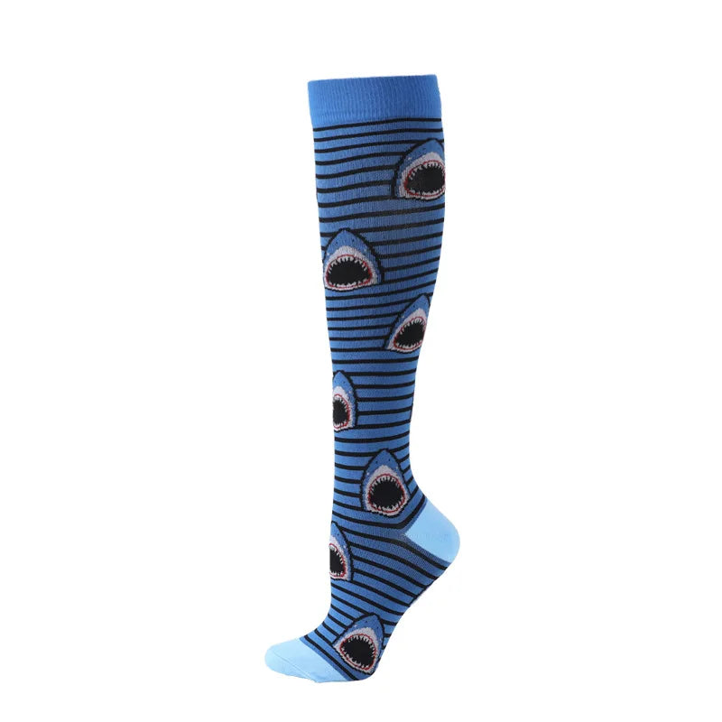 A pair of blue compression socks with a repeating pattern of stylized fish or shark teeth.