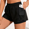 A person wearing black athletic shorts with a mesh pocket and a black sports bra top.