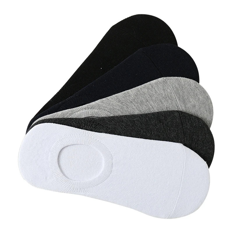A stack of black, gray, and white breathable boat socks viewed from the side.