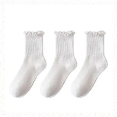 A pack of three white cotton ankle socks with ruffled cuffs.