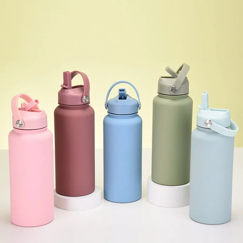 A set of five pink, blue, green, and light blue stainless steel vacuum flask water bottles with straws displayed on a white s