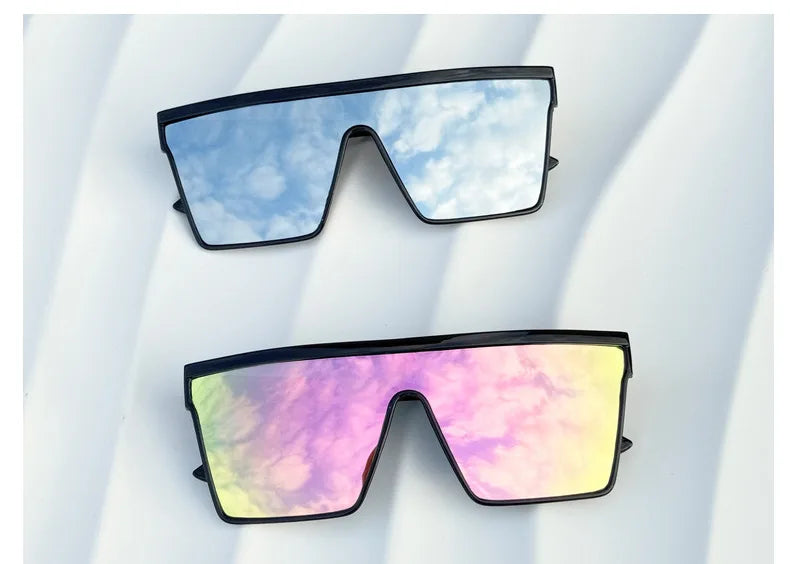 A pair of retro square sunglasses with a blue sky and white cloud pattern against a white background.