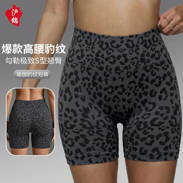 A pair of dark gray leopard print high-waist yoga shorts being worn by a model.