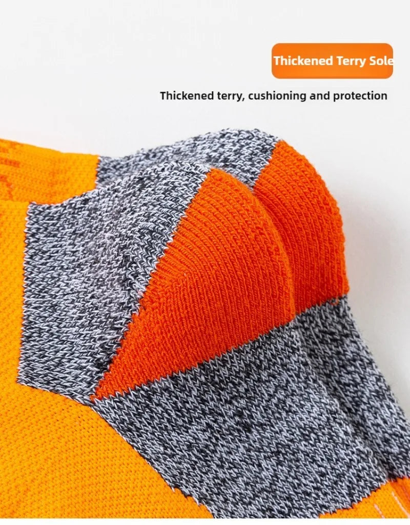 Performance sports ankle socks featuring a striped pattern of orange and gray with a thickened terry sole.