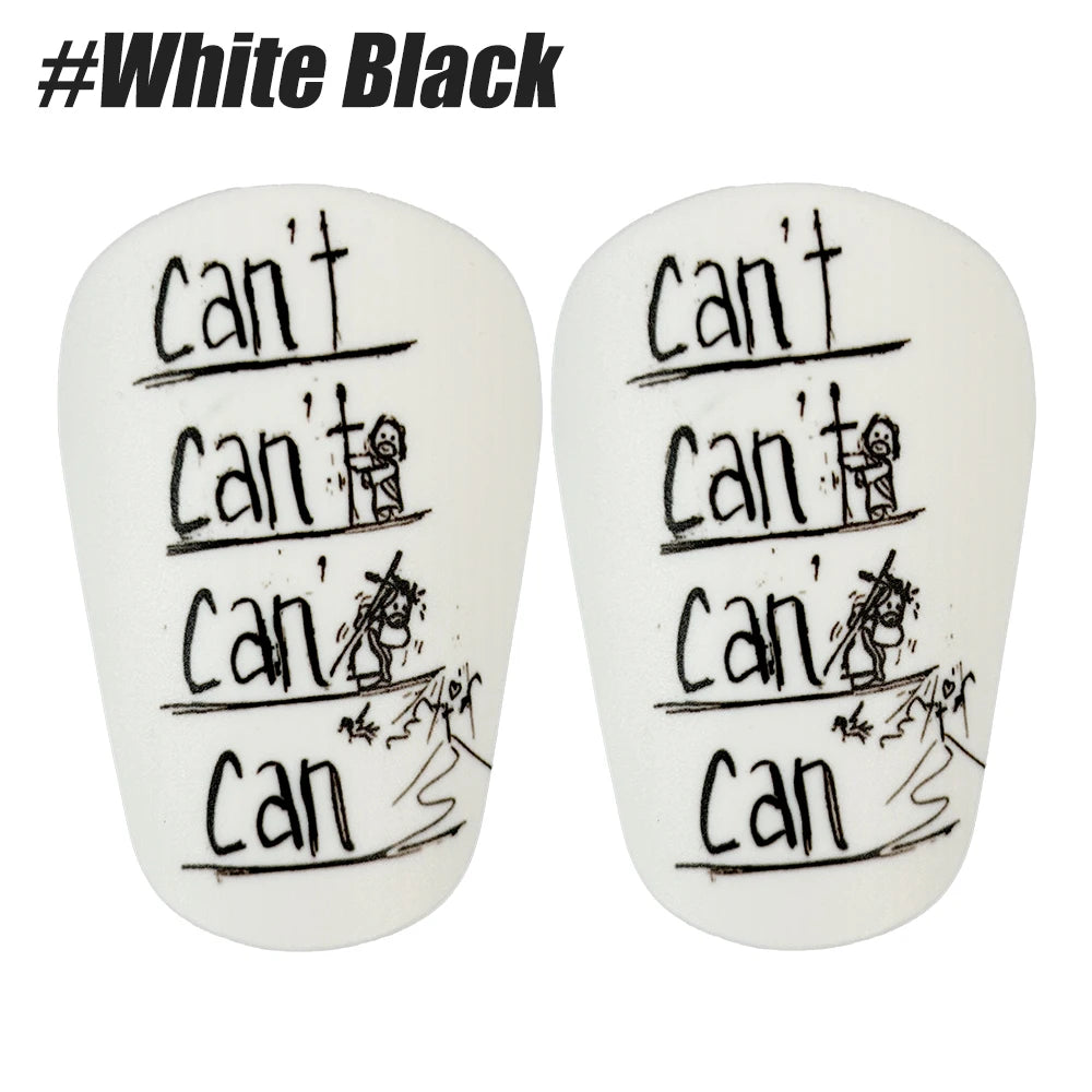 A pair of white shin guards with black text showing various handwriting examples.