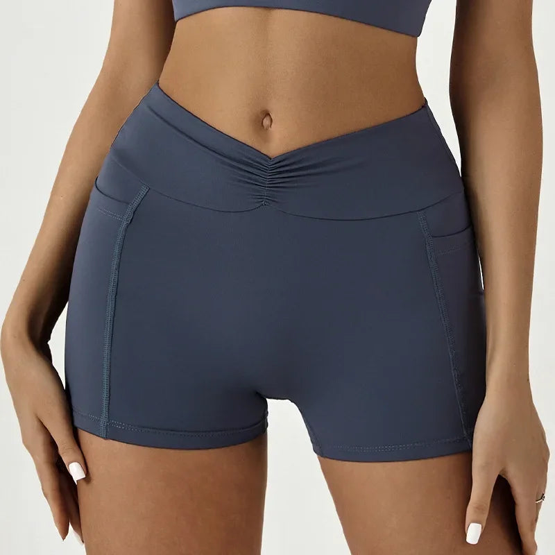 A model wearing dark blue high-waisted yoga and fitness leggings.