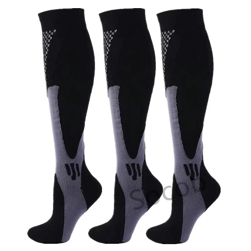 A pair of black compression socks with gray accents shown vertically.