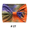 Bandeau en coton tie-dye aux tons de violet, vert et orange.
