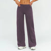 A model is wearing a pair of dark purple high-waist wide-leg yoga leggings.