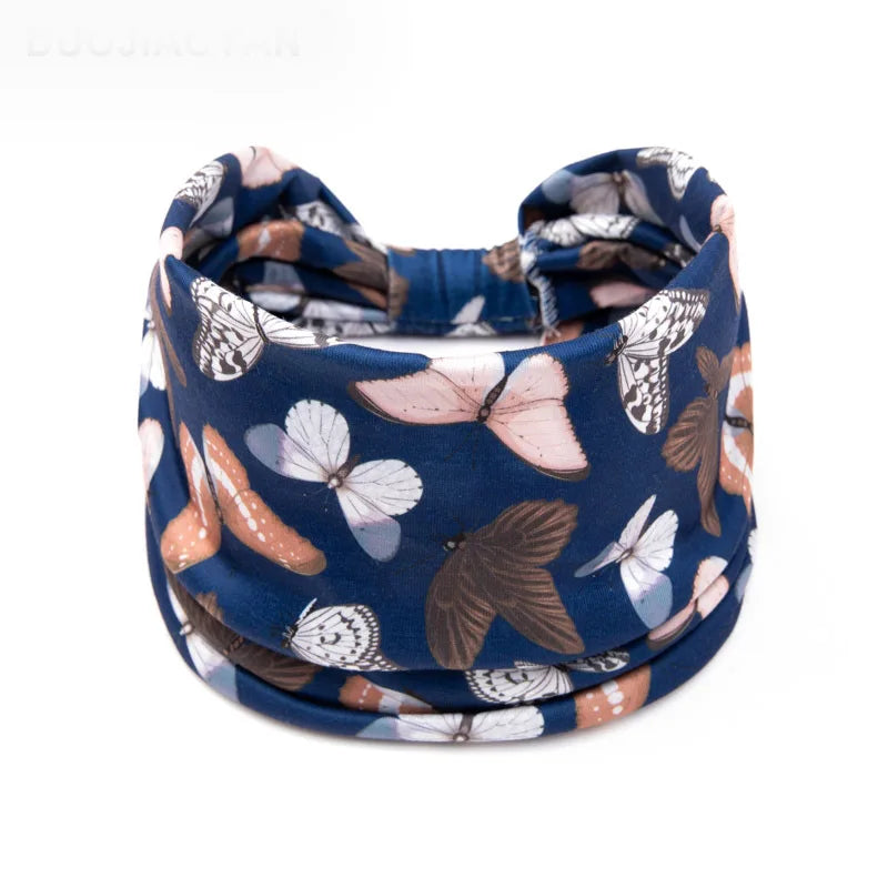 A navy blue floral butterfly patterned headband worn around the head.