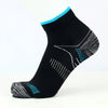 Chaussettes de compression noires avec des accents sarcelle et un motif texturé, vue de côté.