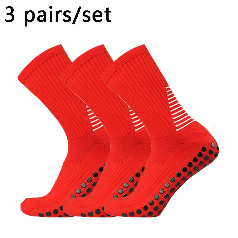 Three pairs of bright red performance football socks laid out for display