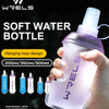 A hand holds a purple soft water bottle with a hanging loop design against a dark background.