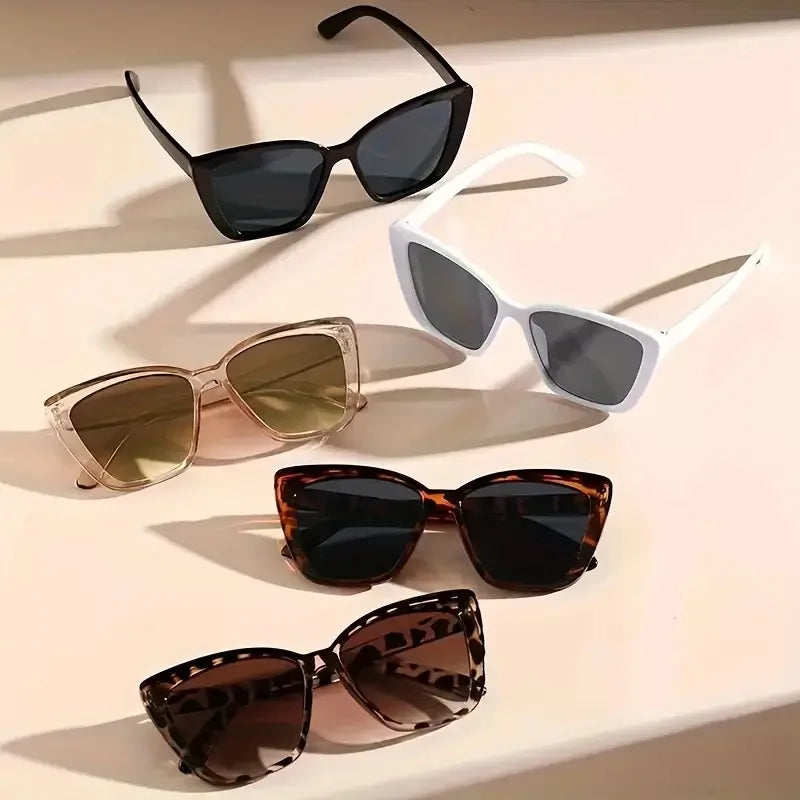 A collection of vintage and modern sunglasses in black, white, gold, and brown tones.