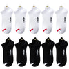 A set of ten white and black breathable ankle boat socks displayed in various angles.