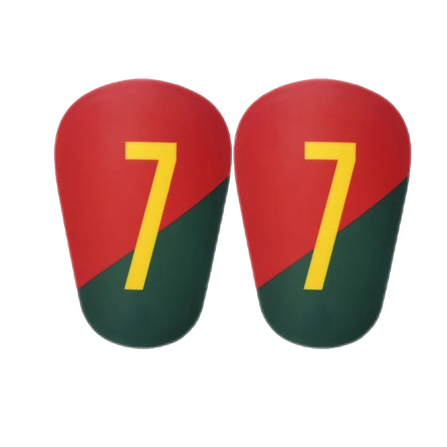 A pair of red and green mini football shin guards for youth and adult players.
