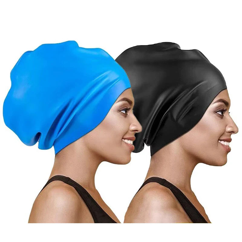 A woman is shown wearing a blue silicone swim cap and a black silicone swim cap.