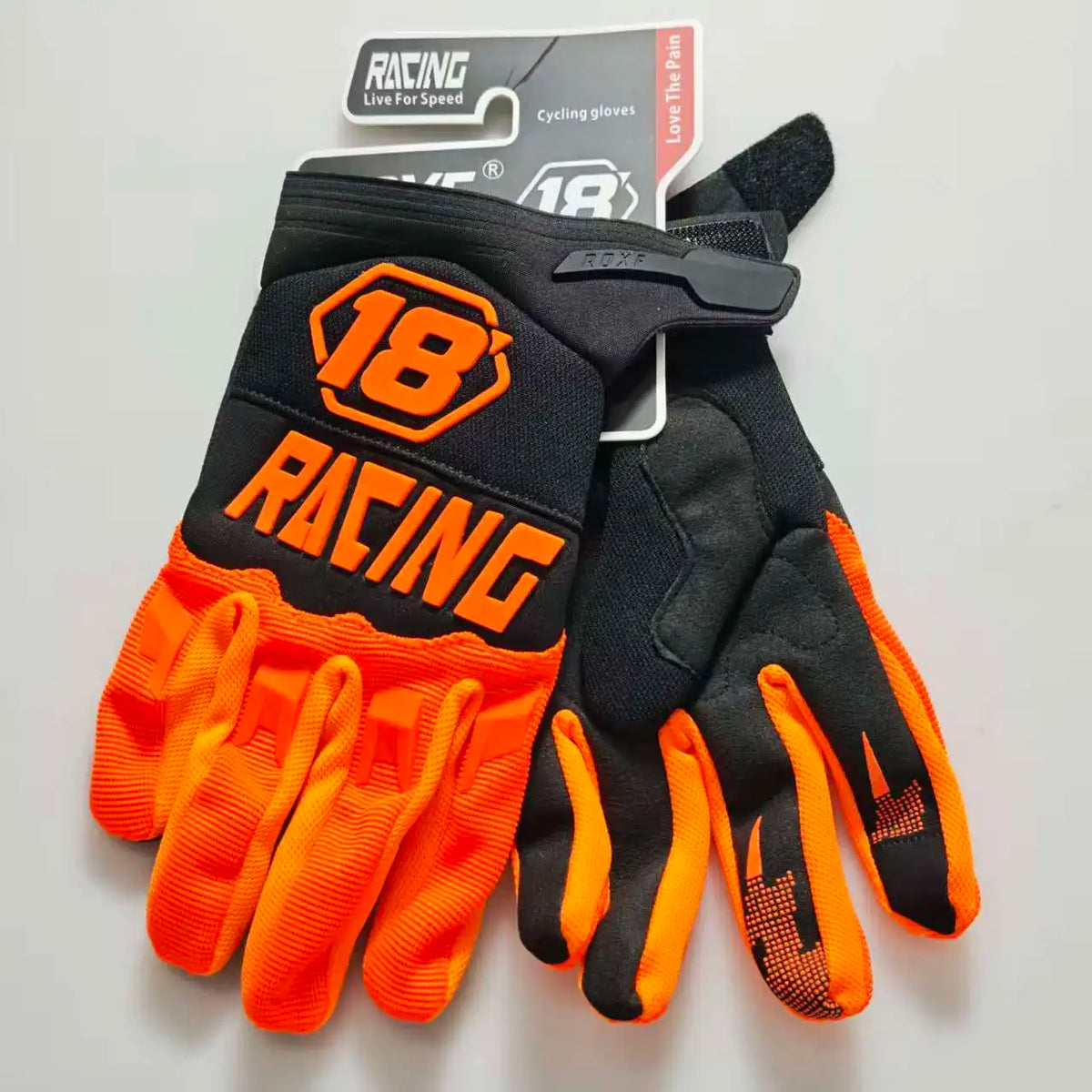 A pair of black and orange racing cycling gloves for riding