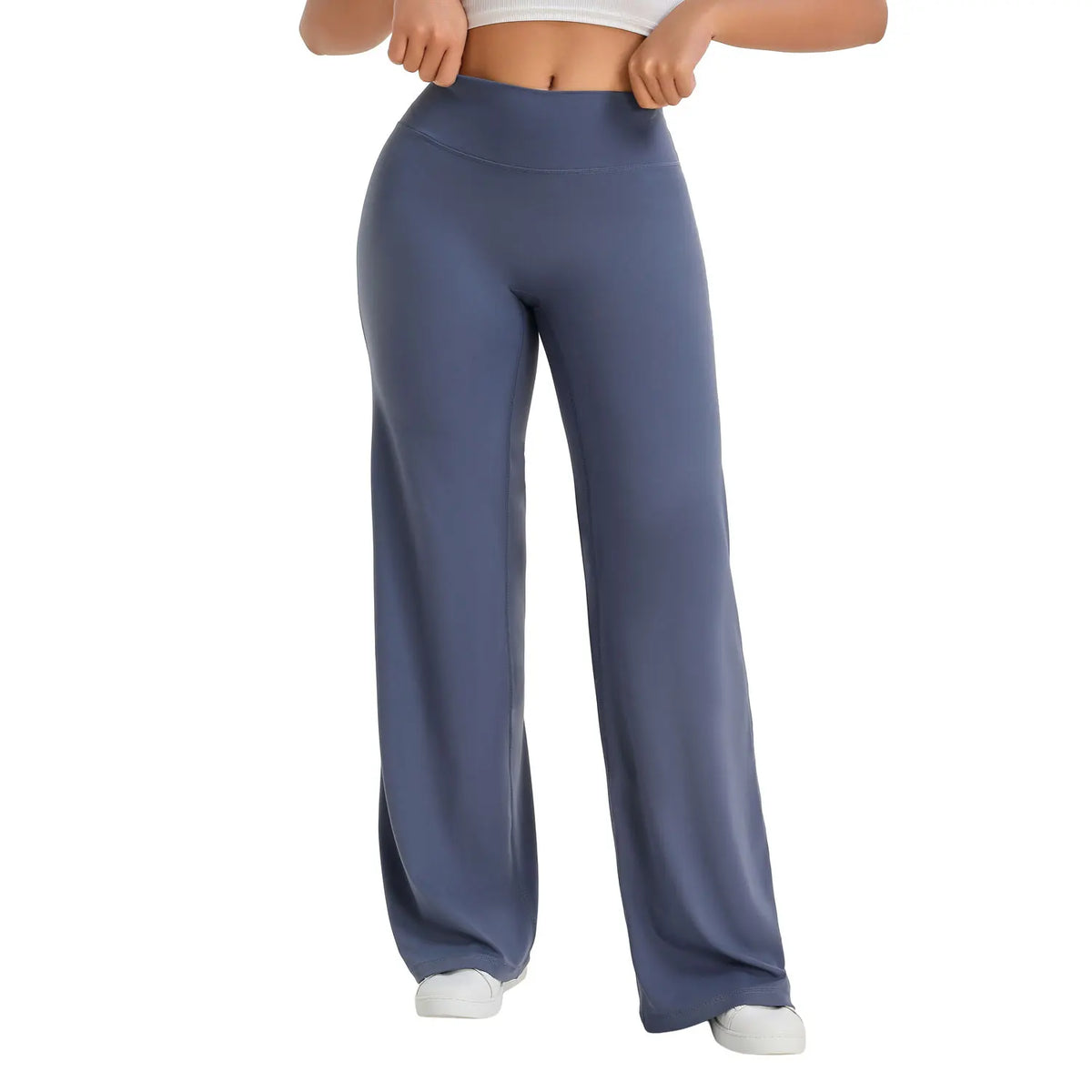 A model is wearing dark blue NCLAGEN SoftMotion straight leg yoga pants.