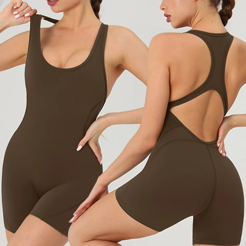A woman models a dark brown, backless fitness jumpsuit.