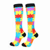 A pair of colorful compression elastic socks featuring a patchwork design of various bright colors.