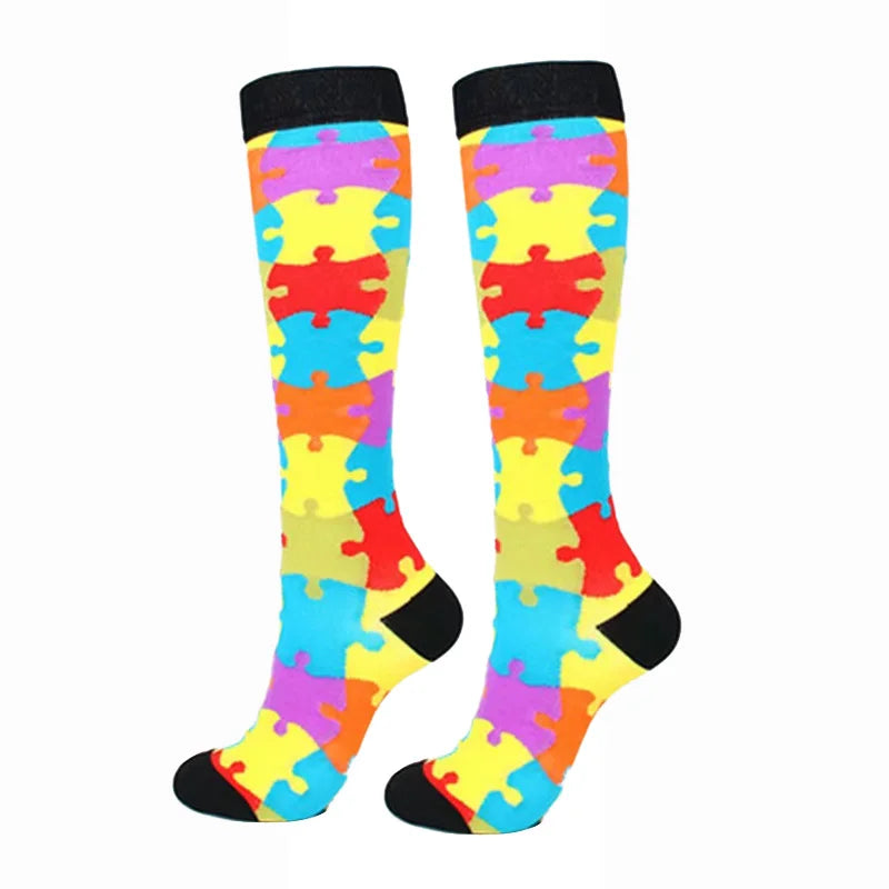 A pair of colorful compression elastic socks featuring a patchwork design of various bright colors.