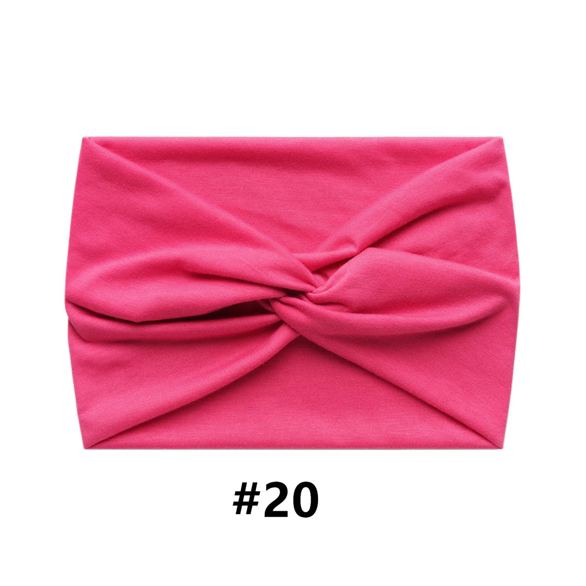 A folded pink fabric item, likely a boho wide turban headband, shown flat.