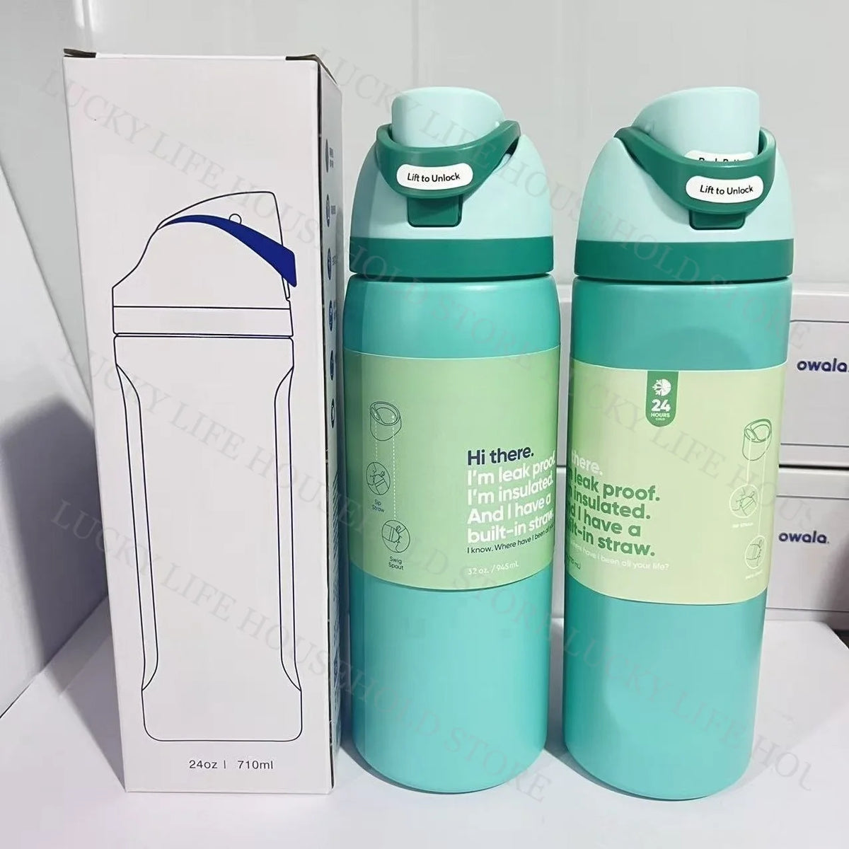 A light teal insulated stainless steel sports water bottle with a green lid is shown next to its packaging box.
