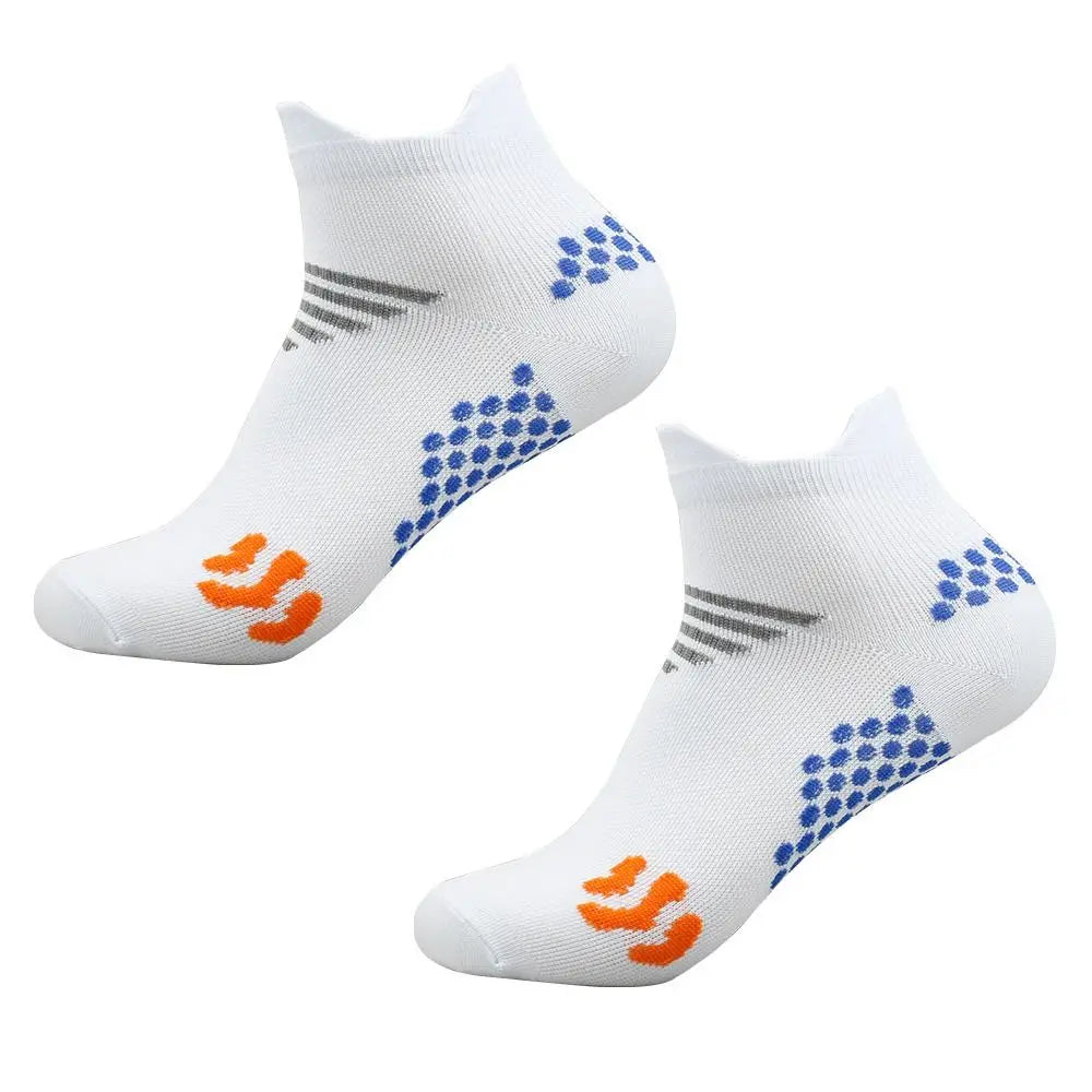 A pair of white cycling and running socks featuring blue geometric patterns and orange stripes.