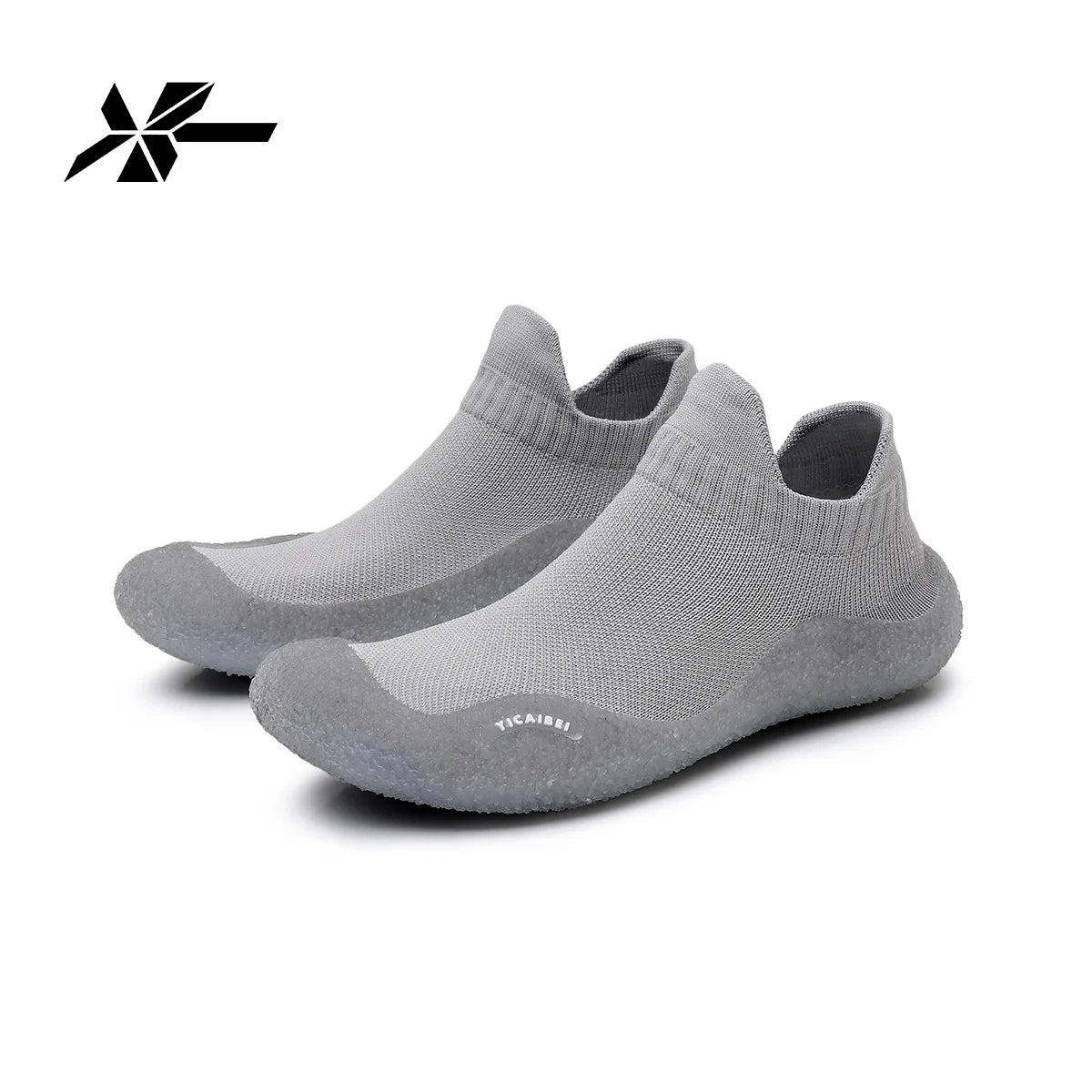 Gray summer quick-dry slip-on shoes shown from the side with a logo mark above them.